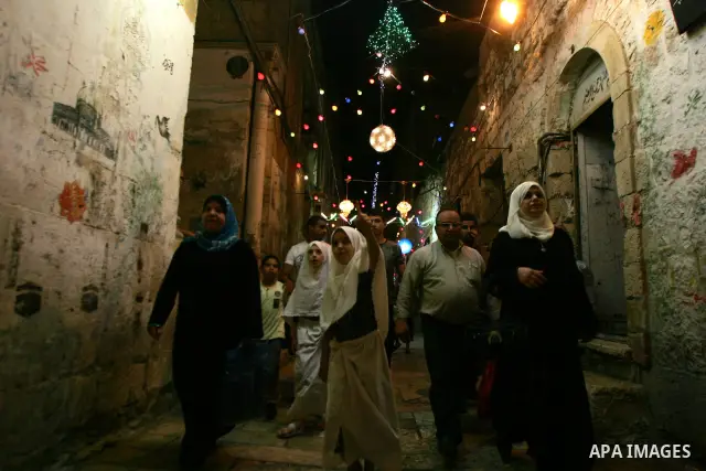 Palestinians walks under decorations ahead of the Muslim holy month of Ramadan in Jerusalem's Old City. Muslims around the world abstain from eating, drinking and sexual relations from sunrise to sunset during Ramadan, t...
