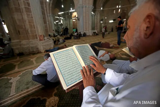 A Palestinian man reads the holy koran on the first day of holy fasting month of Ramadan at al-Omari mosque in Gaza city on Aug. 1, 2011. Throughout the holy month of Ramadan devout Muslims must abstain from food, drink...