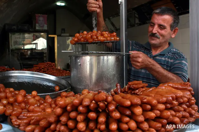 A Palestinian vendor prepares trays of sweets for sale on the first day of the Muslim holy fasting month of Ramadan, in a shop in the West Bank city of Nablus, Monday, Aug. 1, 2011. Muslims throughout the world are celeb...