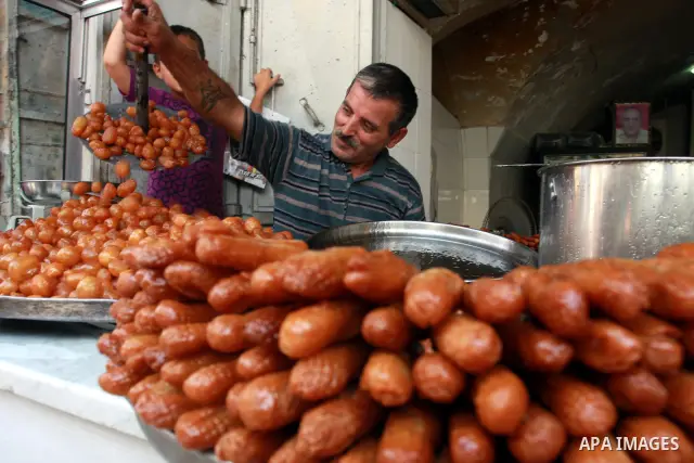 A Palestinian vendor prepares trays of sweets for sale on the first day of the Muslim holy fasting month of Ramadan, in a shop in the West Bank city of Nablus, Monday, Aug. 1, 2011. Muslims throughout the world are celeb...