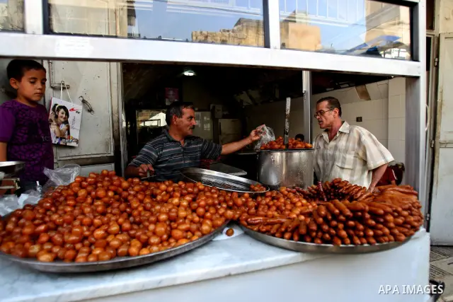 A Palestinian vendor prepares trays of sweets for sale on the first day of the Muslim holy fasting month of Ramadan, in a shop in the West Bank city of Nablus, Monday, Aug. 1, 2011. Muslims throughout the world are celeb...