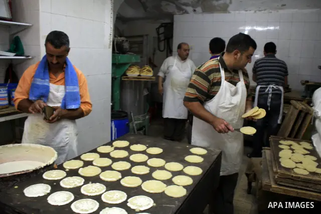 A Palestinian vendor prepares traditional Arab pastries called qatayef on the first day of the Muslim holy month of Ramadan, in a shop in the West Bank city of Nablus, Monday, Aug. 1, 2011. Muslims throughout the world a...