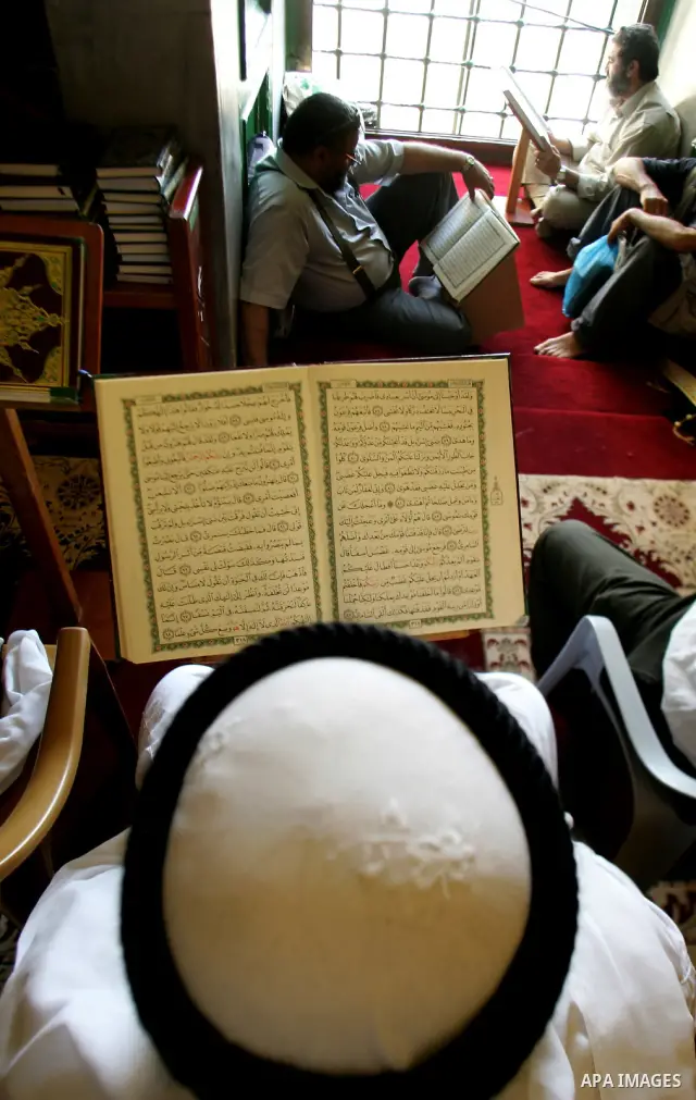 A Palestinian man reads the holy koran on the first day of holy fasting month of Ramadan in Jerusalem on Aug 1, 2011. Throughout the holy month of Ramadan devout Muslims must abstain from food, drink and sex from dawn un...