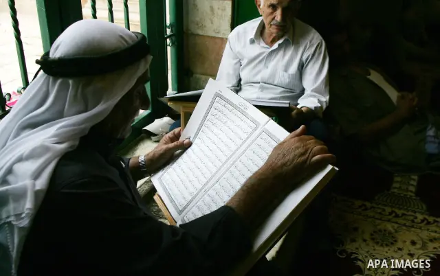 A Palestinian man reads the holy koran on the first day of holy fasting month of Ramadan in Jerusalem on Aug 1, 2011. Throughout the holy month of Ramadan devout Muslims must abstain from food, drink and sex from dawn un...