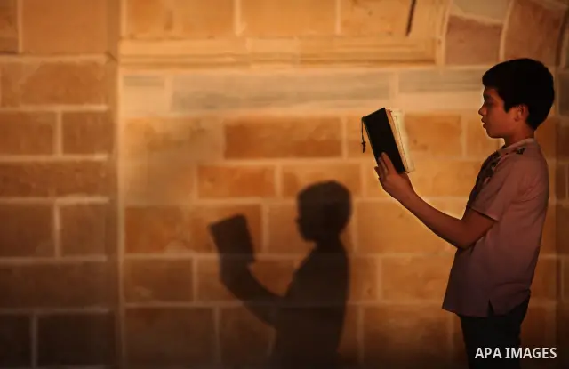 Palestinian boys read the Koran at the al-Omari mosque in Gaza City on the first day of the Muslim holy fasting month of Ramadan on 01 August 2011. Muslims throughout the world are celebrating the holy fasting month of R...