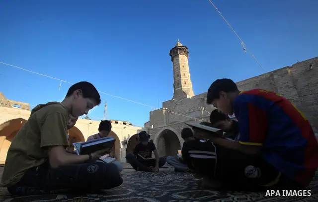 Palestinian boys read the Koran at the al-Omari mosque in Gaza City on the first day of the Muslim holy fasting month of Ramadan on 01 August 2011. Muslims throughout the world are celebrating the holy fasting month of R...