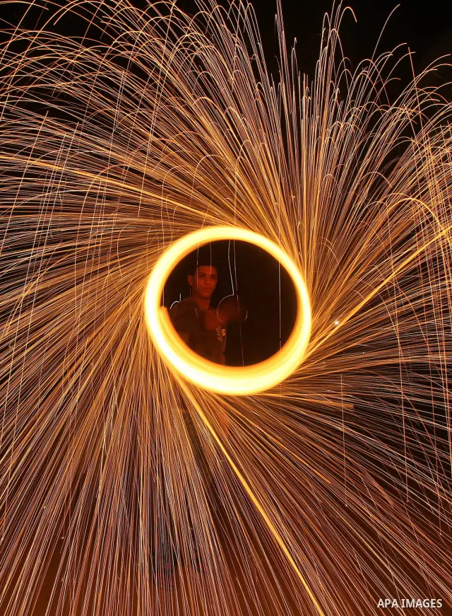 Palestinian boy plays with fireworks to celebrate the beginning of the Muslim holy fasting month of Ramadan in Gaza City on 01 August 2011. Muslims throughout the world are celebrating the holy fasting month of Ramadan,...