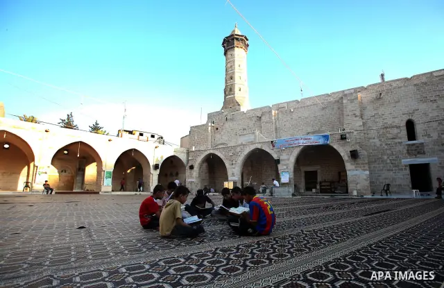 Palestinian boys read the Koran at the al-Omari mosque in Gaza City on the first day of the Muslim holy fasting month of Ramadan on 01 August 2011. Muslims throughout the world are celebrating the holy fasting month of R...