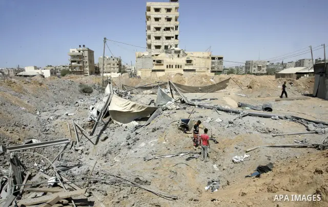 Palestinians inspect the damage outside a smuggling tunnel following an overnight Israeli airstrike in Rafah, on the border between Egypt and southern Gaza Strip, Tuesday, Aug 2, 2011. Israel bombed the tunnel in respons...