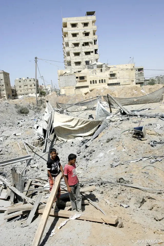 Palestinians inspect the damage outside a smuggling tunnel following an overnight Israeli airstrike in Rafah, on the border between Egypt and southern Gaza Strip, Tuesday, Aug 2, 2011. Israel bombed the tunnel in respons...