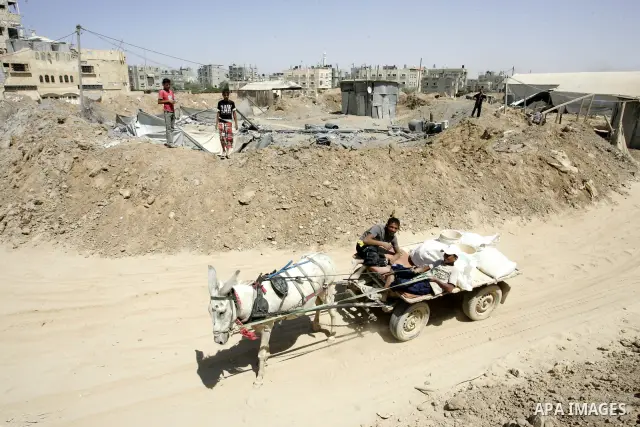 Palestinians inspect the damage outside a smuggling tunnel following an overnight Israeli airstrike in Rafah, on the border between Egypt and southern Gaza Strip, Tuesday, Aug 2, 2011. Israel bombed the tunnel in respons...