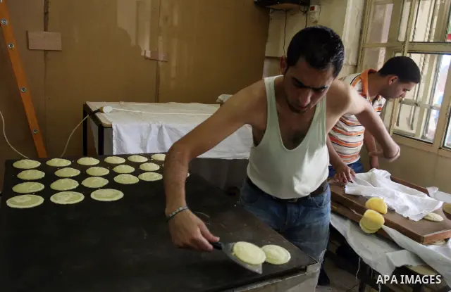 A Palestinian vendor prepares qatayef, a traditional pancake for Ramadan, at a shop in the West Bank city of Ramallah August 2, 2011. Muslims around the world abstain from eating, drinking and conducting sexual relations...