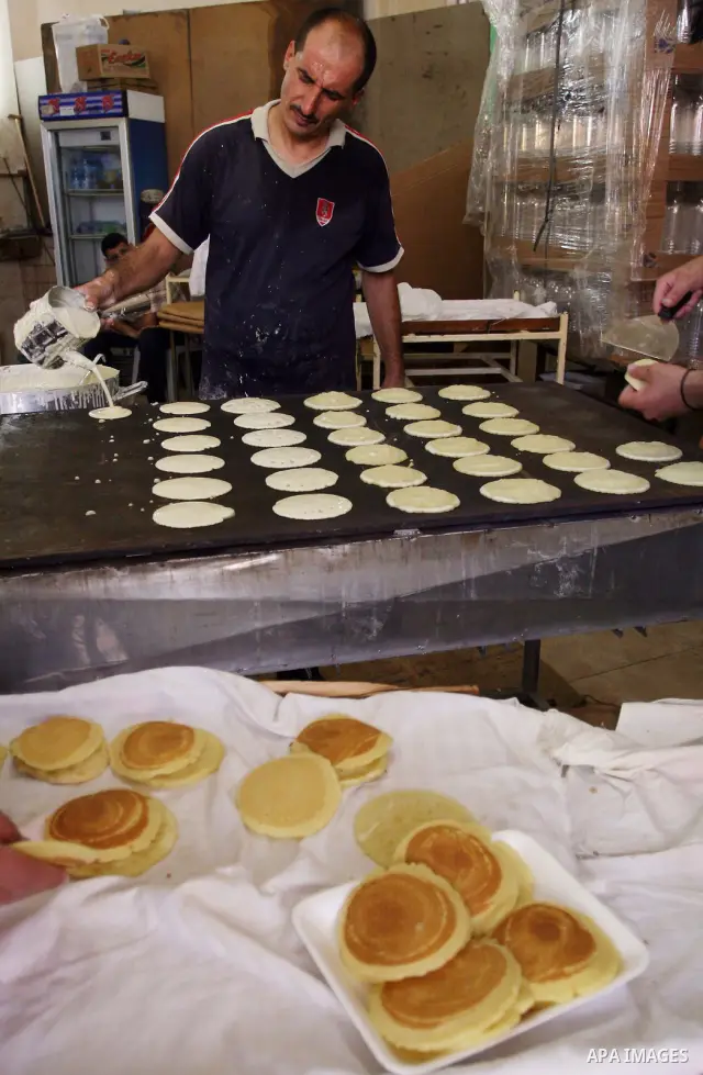 A Palestinian vendor prepares qatayef, a traditional pancake for Ramadan, at a shop in the West Bank city of Ramallah August 2, 2011. Muslims around the world abstain from eating, drinking and conducting sexual relations...