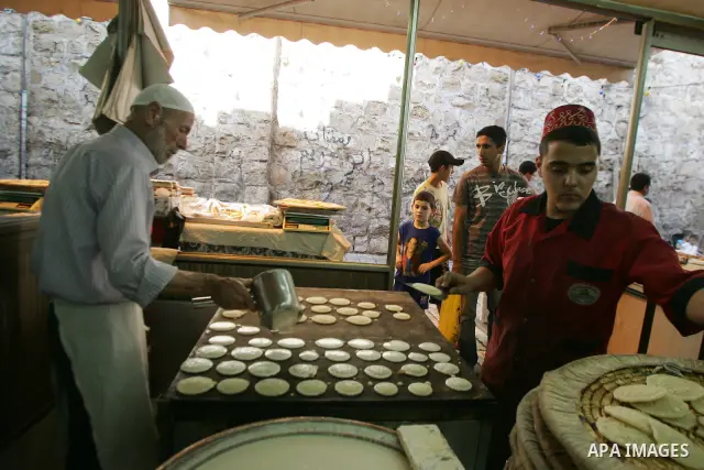 A Palestinian vendor prepares qatayef, a traditional pancake for Ramadan, before selling it at a shop in the old city of jerusalem August 2, 2011. Muslims around the world abstain from eating, drinking and conducting sex...