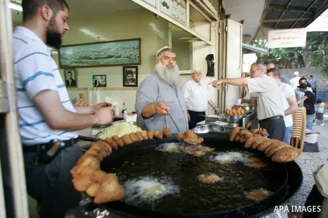 A Palestinian vendor prepares qatayef, a traditional pancake for Ramadan, before selling it at a shop in the old city of jerusalem August 2, 2011. Muslims around the world abstain from eating, drinking and conducting sex...