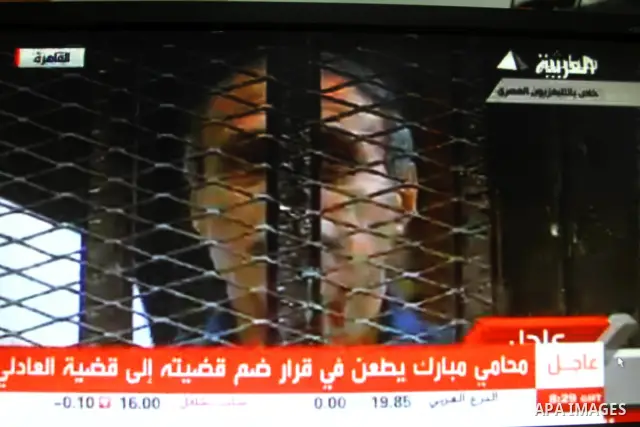 This video image taken from Egyptian State Television shows former Egyptian interior minister Habib el-Adly, in a cage of mesh and iron bars in a Cairo courtroom Wednesday Aug. 3, 2011. An ailing, 83-year-old Hosni Mubar...