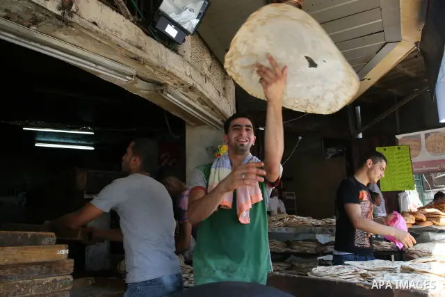 A Palestinian vendor bakes traditional bread on a fasting day of Ramadan in the West Bank city of Ramallah, on Aug. 3, 2011. Muslims around the world abstain from eating, drinking and conducting sexual intercourse from s...