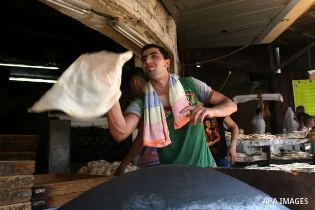 A Palestinian vendor bakes traditional bread on a fasting day of Ramadan in the West Bank city of Ramallah, on Aug. 3, 2011. Muslims around the world abstain from eating, drinking and conducting sexual intercourse from s...