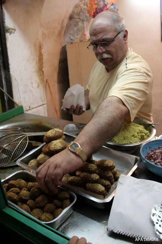 A Palestinian vendor sells traditional food "felafel" in his shop in the West Bank city of Hebron August 3, 2011. Muslims around the world abstain from eating, drinking and conducting sexual relations from sunrise to sun...