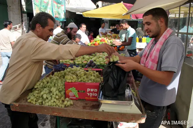 Palestinians shop for food at a market in the West Bank city of Hebron August 3, 2011. Muslims around the world abstain from eating, drinking and conducting sexual relations from sunrise to sunset during Ramadan, the hol...