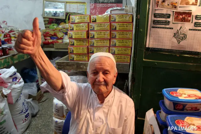 A Palestinian vendor sits in his shop at a market in the West Bank city of Hebron August 3, 2011. Muslims around the world abstain from eating, drinking and conducting sexual relations from sunrise to sunset during Ramad...