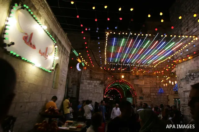 Palestinians walks under decorations in the nights of the holy month of Ramadan in Jerusalem's Old City on Aug. 3, 2011. Muslims around the world abstain from eating, drinking and sexual relations from sunrise to sunset...