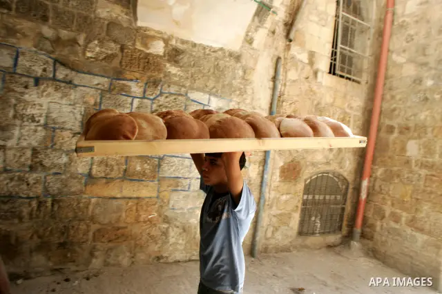 A Palestinians boy sells traditional bread in the holy month of Ramadan in Jerusalem's Old City on Aug. 3, 2011. Muslims around the world abstain from eating, drinking and sexual relations from sunrise to sunset during R...