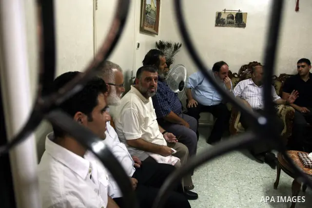 A Palestinian commander of the Hamas Islamist movement, Sheikh Hassan Yusef, 56, receives visitors in his home in the West Bank city of Ramallah after he was released from an Israeli jails, on Aug. 4, 2011. as Israel fre...