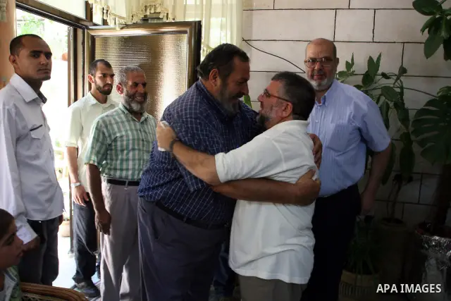 A Palestinian commander of the Hamas Islamist movement, Sheikh Hassan Yusef, 56, hugs his relatives in his home in the West Bank city of Ramallah after he was released from an Israeli jails, on Aug. 4, 2011. as Israel fr...