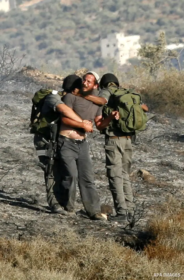 Israeli soldiers break up a fight between Jewish settlers and Palestinians over farming land between the Jewish settlement of Bracha and the nearby West Bank village of Burin, near Nablus, Thursday, Aug. 4, 2011.The IDF...