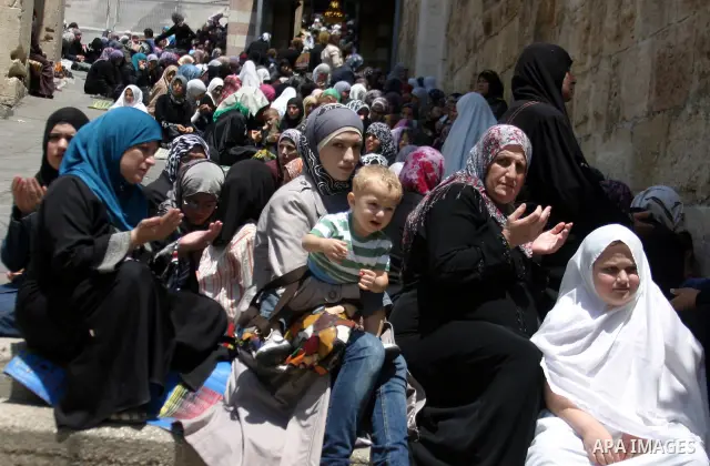 Israeli soldiers (not seen) stand guard as the Palestinian women perform the first Friday prayer of the holy Muslim month of Ramadan in front of the closed Ibrahimi mosque in the West Bank city of Hebron, August 05 2011....
