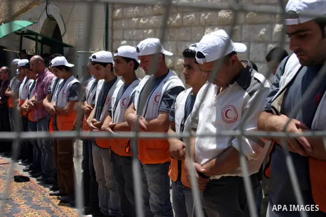 Palestinian Muslims pray at the entrance to the Ibrahimi Mosque, in the West Bank city of Hebron, on Aug. 5, 2011. Muslims throughout the world are marking the month of Ramadan, during which they refrain from eating, dri...