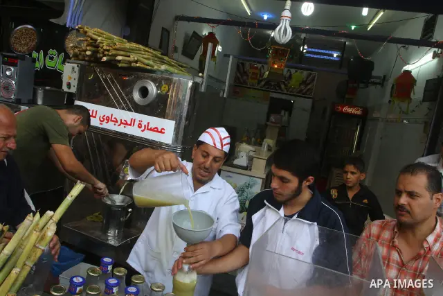 Palestinian vendor prepares different types of juice at his shop on the sixth day of the holy month of Ramadan in Gaza City on Aug. 6, 2011 . Muslims all over the world fast from dawn to dusk during the holy month of Ram...