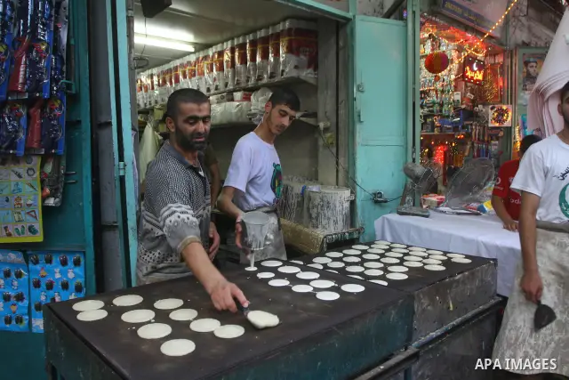 A Palestinian vendor prepares qatayef, a traditional pancake for Ramadan, at a shop in Gaza city on Aug. 6, 2011. Muslims around the world abstain from eating, drinking and conducting sexual relations from sunrise to sun...