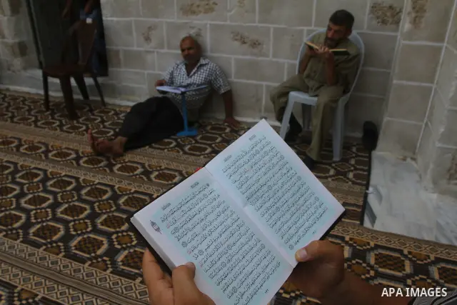 Palestinian Muslims read the holy Koran at al-Omari Mosque in Gaza city, during the Muslim holy fasting month of Ramadan, on Aug. 6, 2011. Muslims throughout the world are celebrating the holy fasting month of Ramadan, t...