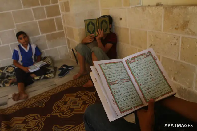 Palestinian boys read the holy Koran at al-Omari Mosque in Gaza city, during the Muslim holy fasting month of Ramadan, on Aug. 6, 2011. Muslims throughout the world are celebrating the holy fasting month of Ramadan, the...