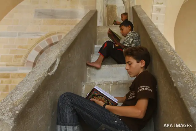 Palestinian boys read the holy Koran at al-Omari Mosque in Gaza city, during the Muslim holy fasting month of Ramadan, on Aug. 6, 2011. Muslims throughout the world are celebrating the holy fasting month of Ramadan, the...