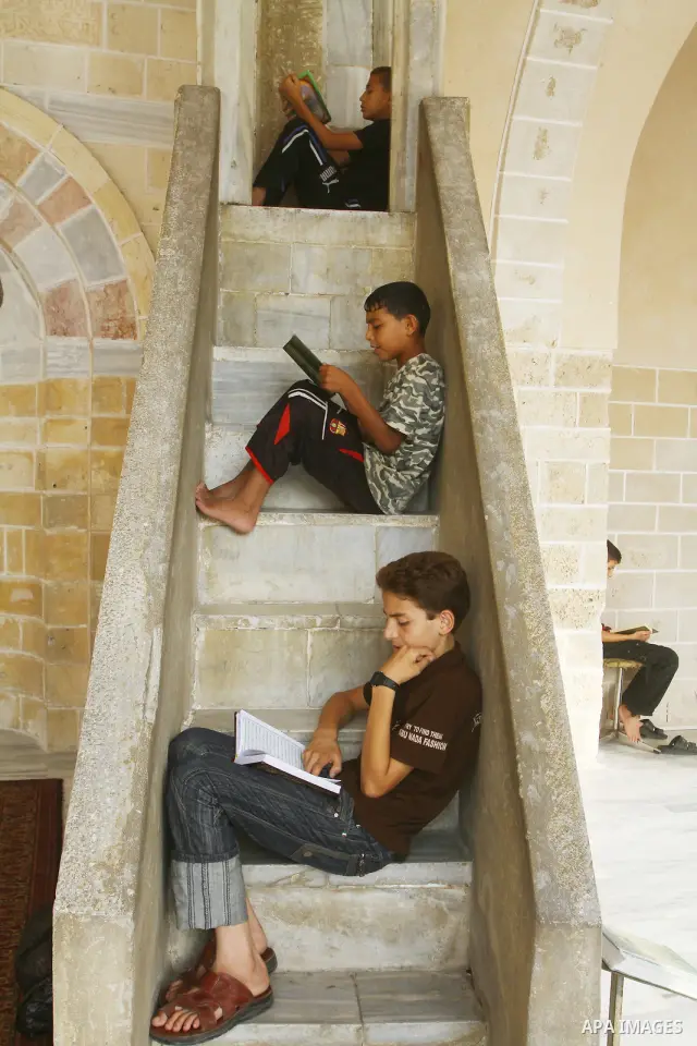 Palestinian boys read the holy Koran at al-Omari Mosque in Gaza city, during the Muslim holy fasting month of Ramadan, on Aug. 6, 2011. Muslims throughout the world are celebrating the holy fasting month of Ramadan, the...