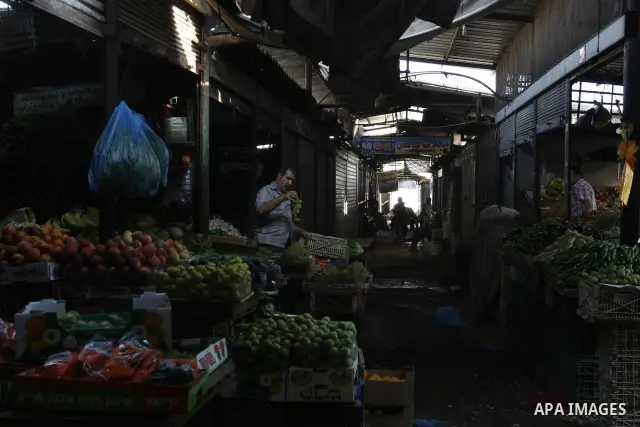 A Palestinian vendor sells vegetables at a wholesale market in Gaza city on Aug. 6, 2011. Muslims around the world abstain from eating, drinking and conducting sexual relations from sunrise to sunset during Ramadan, the...