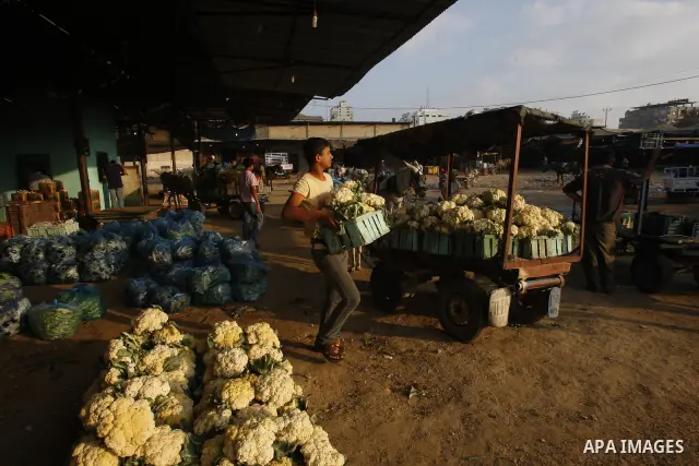 A Palestinian vendor sells vegetables at a wholesale market in Gaza city on Aug. 6, 2011. Muslims around the world abstain from eating, drinking and conducting sexual relations from sunrise to sunset during Ramadan, the...