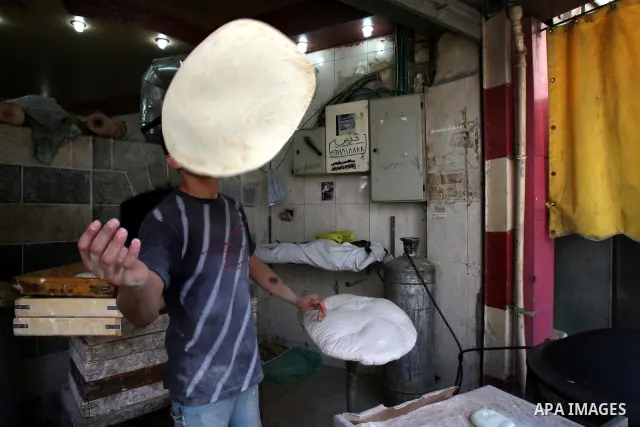 A Palestinian vendor bakes traditional bread on a fasting day of Ramadan in his shop in the West Bank city of Nablus on Aug. 7, 2011. Muslims around the world abstain from eating, drinking and conducting sexual intercour...
