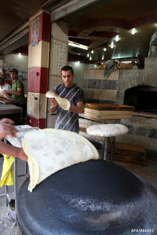 A Palestinian vendor bakes traditional bread on a fasting day of Ramadan in his shop in the West Bank city of Nablus on Aug. 7, 2011. Muslims around the world abstain from eating, drinking and conducting sexual intercour...