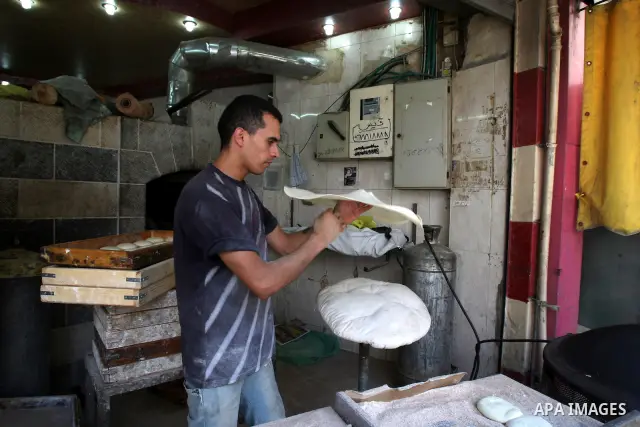 A Palestinian vendor bakes traditional bread on a fasting day of Ramadan in his shop in the West Bank city of Nablus on Aug. 7, 2011. Muslims around the world abstain from eating, drinking and conducting sexual intercour...