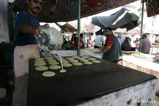 A Palestinian vendor prepares qatayef, a traditional pancake for Ramadan, at a shop in Rafah, southern Gaza Strip on Aug. 7, 2011. Muslims around the world abstain from eating, drinking and conducting sexual relations fr...