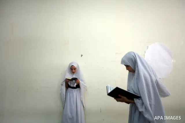 Palestinian Muslim girls read the holy Koran during a mass Koran reading session at a mosque in Gaza City, Gaza Strip, 07 August 2011. Muslims around the world are observing the fasting month of Ramadan during which they...