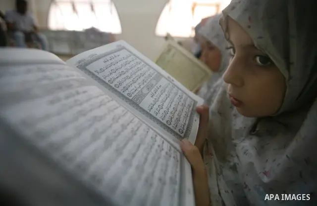 Palestinian Muslim girls read the holy Koran during a mass Koran reading session at a mosque in Gaza City, Gaza Strip, 07 August 2011. Muslims around the world are observing the fasting month of Ramadan during which they...
