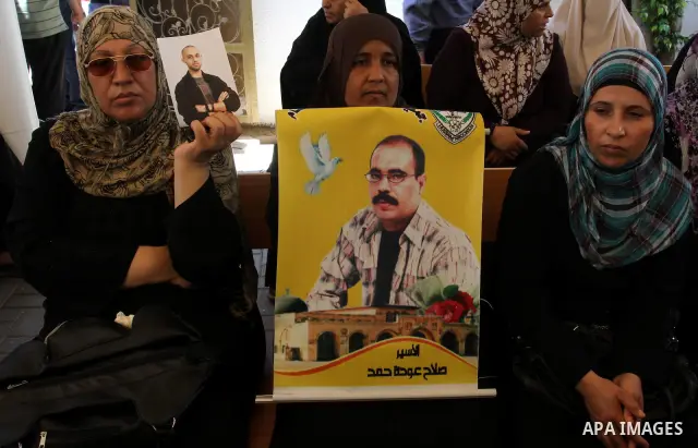 Palestinian women hold pictures of their prisoned relatives in Israeli jails as they gather in a weekly activity calling for their liberty at the Red Cross headquarters in Gaza City on Aug. 8, 2011. About 7000 prisoners...