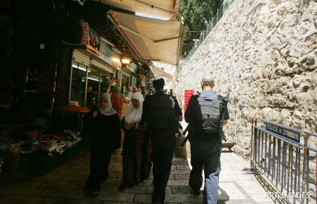 Israeli border guard keep watch Palestinians as they shop at a market, in the old city of Jerusalem on Aug. 8, 2011. Muslims throughout the world are marking the month of Ramadan, during which they refrain from eating, d...