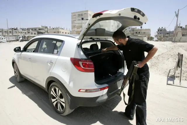 A Palestinian Hamas policeman during searching cars near the tunnels between Egypt and Gaza border, in part of a campaign to search vehicles, in Rafah, southern Gaza Strip on Aug. 8, 2011. Photo by Abed Rahim Khatib