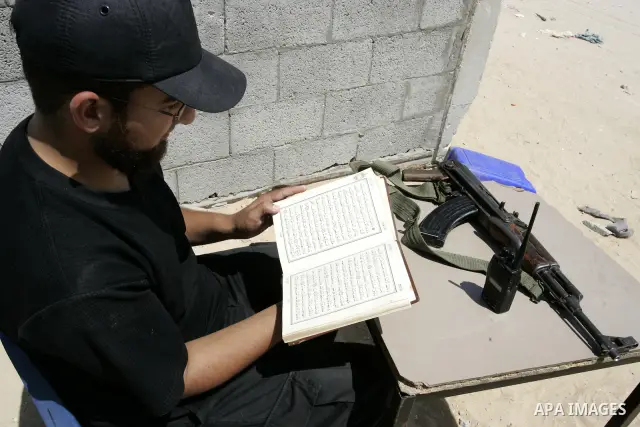 A Palestinian Hamas policeman reads the holy Koran near the tunnels between Egypt and Gaza border in Rafah, southern Gaza Strip on Aug. 8, 2011. Muslims around the world refrain from eating, drinking and sexual intercour...